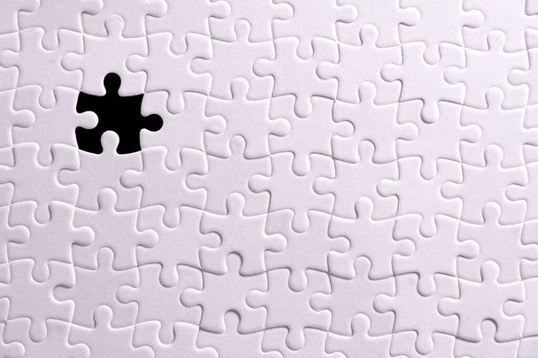 White puzzle and one missing puzzle piece - Zdjęcie, obraz