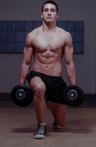 Young Men Exercising Lunges with Weights - 写真・画像