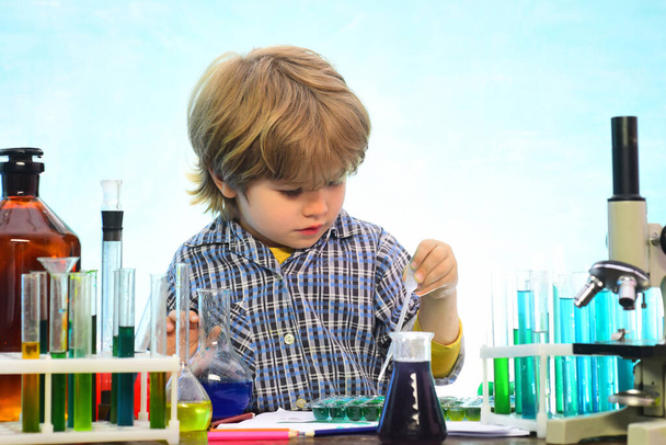 Little kids scientist earning chemistry in school lab. What is taught in chemistry. Lab microscope and testing tubes. School concept. Back to school and home schooling - Foto, Bild