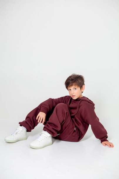 boy in tracksuit on white background - Фото, изображение