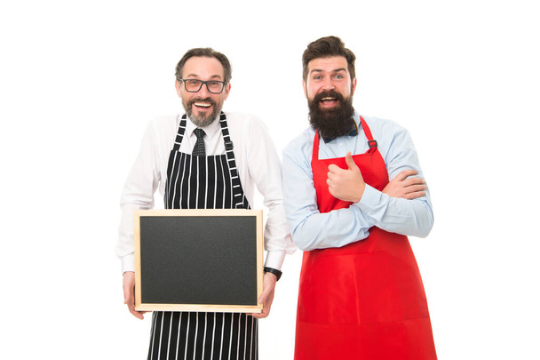 partners celebrate start up. menu planning. happy chef team in apron. bearded men with blackboard, copy space. cafe restaurant opening. catering business. welcome on board. menu board. empty board - Foto, Imagem
