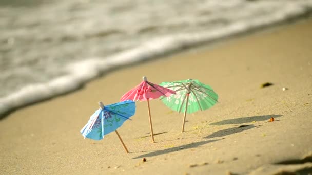 Small beach umbrellas made of paper for a cocktail stand in the sand beach - Footage, Video