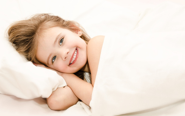 Adorable little girl waked up in her bed  - Fotografie, Obrázek