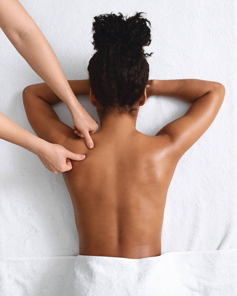 アフリカ系アメリカ人裸女性取得リラックスバックマッサージオンホワイト - 写真・画像