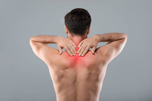 Strong man with neck pain, back view - Foto, Bild