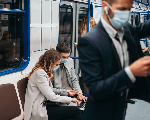image of passengers in protective masks in a subway car. - 写真・画像