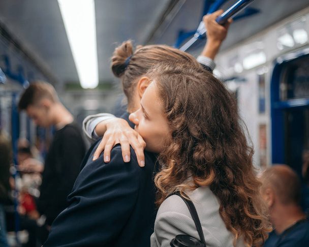 couple in love embraces on a subway train. - Fotó, kép