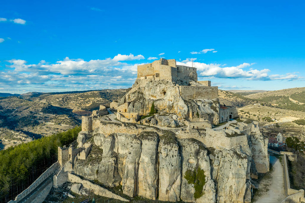 Aerial panoramic view of medieval walled Morella hilltop rampart and castle with blue sky in Spain - Photo, Image