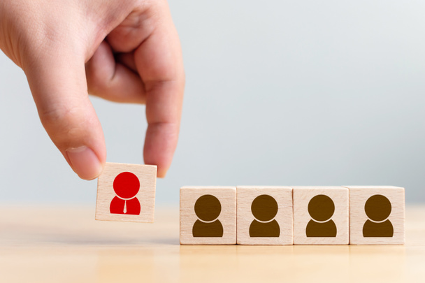 Human resource management and recruitment business concept. Wooden cube blocks are different with human icons, red, prominent crowds - Photo, Image