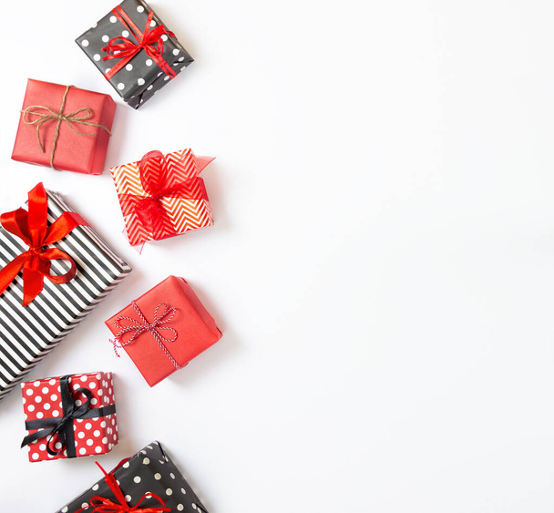 Top view of gift boxes wrapped in black and white striped, dotted and red paper over a white background. Various designs wrapped presents. Copy space - Photo, Image