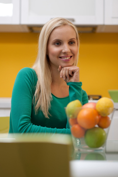 Beautiful young woman in her kitchen - Foto, afbeelding