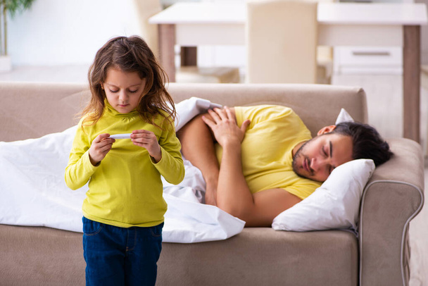 Small girl looking after her sick father - Photo, Image