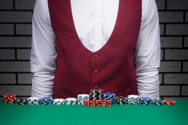 the croupier spread out the blackjack chips and dice on the table - Fotoğraf, Görsel
