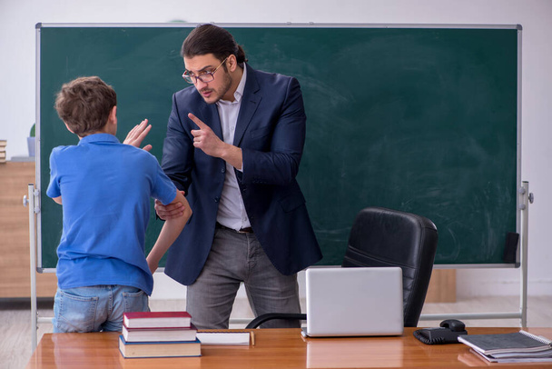 Young male teacher and schoolboy in the classroom - Foto, Imagem