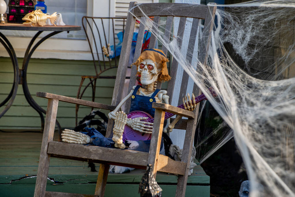 Skeleton sitting in a chair and playing on banjo at halloween - Photo, image