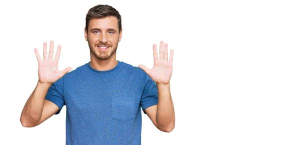 Handsome caucasian man wearing casual clothes showing and pointing up with fingers number ten while smiling confident and happy.  - Fotoğraf, Görsel