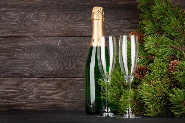 Christmas greeting card with fir tree, champagne glasses, gift boxes and space for your xmas greetings - Photo, Image