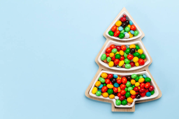 Christmas greeting card with fir tree shaped sweets. Top view flat lay with space for your xmas greetings - Foto, immagini