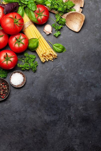Italian cuisine ingredients. Garden tomatoes, pasta, herbs and spices. Top view with copy space. Flat lay - Fotoğraf, Görsel