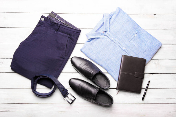 Un ensemble de vêtements classiques pour hommes dans un bleu tendance sur fond blanc. Pose plate. - Photo, image