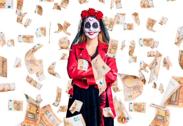 Woman wearing day of the dead costume over background happy face smiling with crossed arms looking at the camera. positive person. - 写真・画像