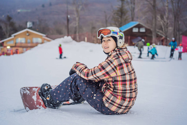 Woman snowboarder on a sunny winter day at a ski resort - Zdjęcie, obraz