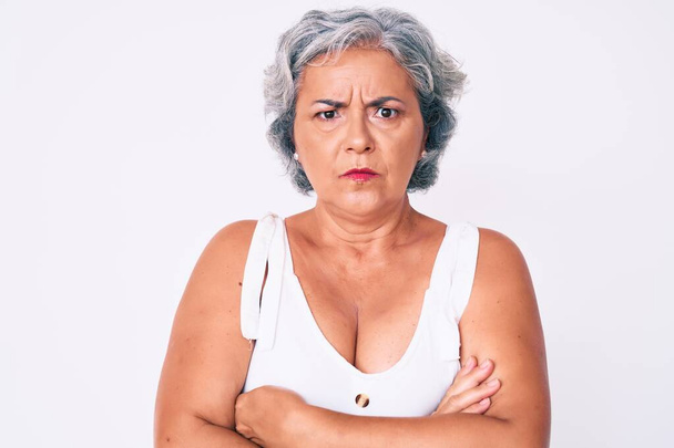 Senior hispanic woman wearing casual clothes skeptic and nervous, disapproving expression on face with crossed arms. negative person.  - Photo, Image