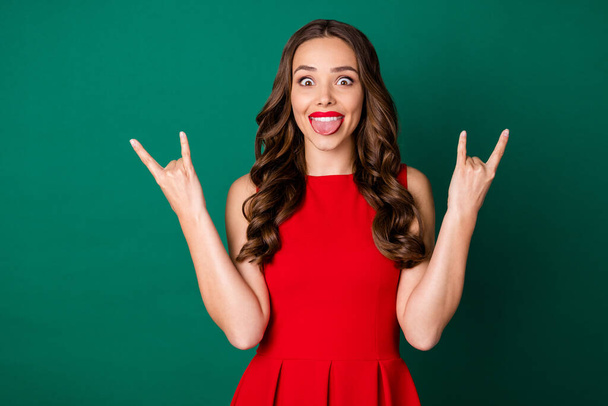 Portrait of her she nice-looking attractive charming lovely cheerful cheery wavy-haired girl showing double horn symbol having fun fooling good mood isolated over green color background - Fotografie, Obrázek