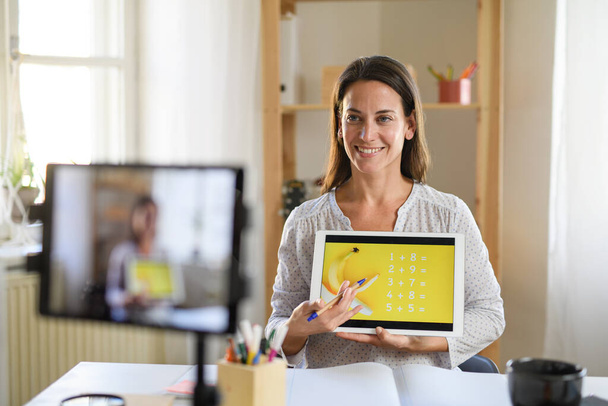 Woman teacher teaching online, coronavirus and online distance learning concept. - Фото, изображение