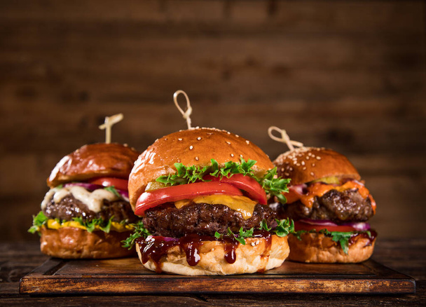 Tasty burgers on wooden table. - Foto, Imagem