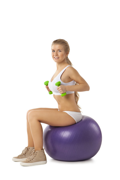 Woman exercising with dumbbells and fitball - Foto, imagen