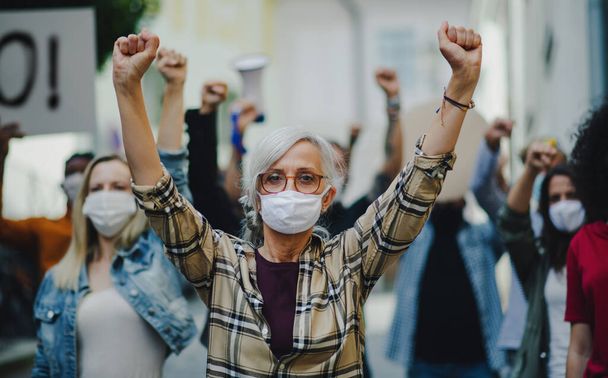 Group of people activists protesting on streets, women march, demonstration and coronavirus concept. - Fotografie, Obrázek