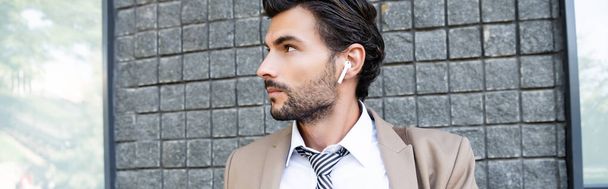 businessman in wireless earphones and suit, banner - Zdjęcie, obraz