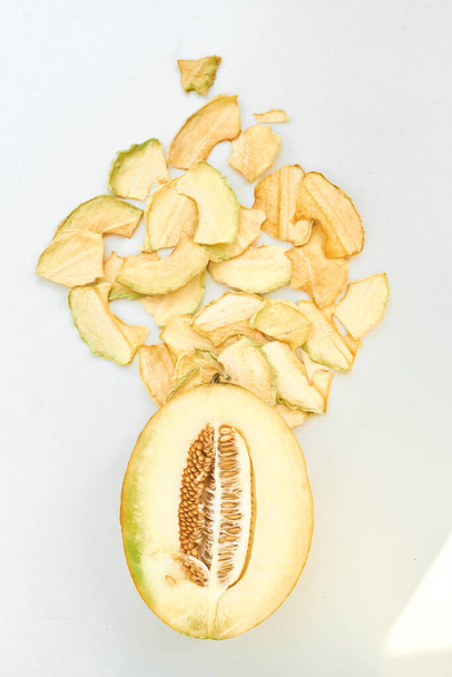 Fruit chips with melon on white background. Top view. - Foto, Imagem