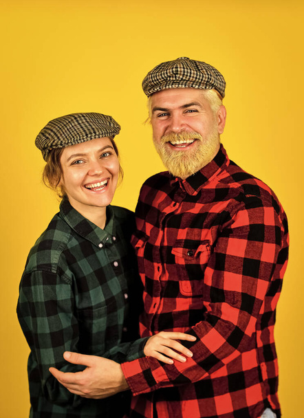 happy man and woman checkered shirt and hat. Happy family concept. hippie and hipster. couple vintage fashion. follow old fashioned tradition. bearded man and girl peaked cap. retro couple of farmers - Photo, image