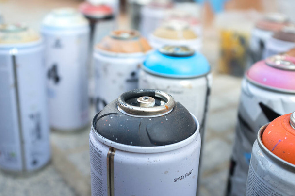 Used paint aerosol cans without valves. Selective focus - Photo, Image