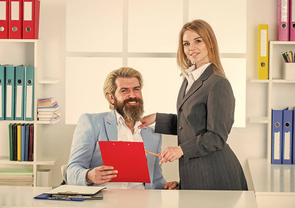 business partnership success. modern office life. together in business. businesspeople in office. businessman and businesswoman at workplace. too much work with documents - 写真・画像