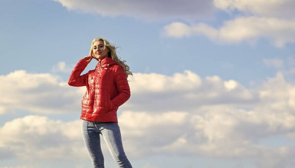 Wind of changes. Female psychology. Woman fashion model outdoors. Woman enjoy cool weather. Matching style and class with luxury and comfort. Fashion outfit. Windy day. Girl red jacket cloudy sky - Fotoğraf, Görsel