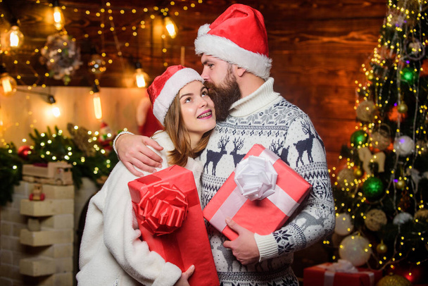 Loving couple cuddle christmas tree background. Romantic feelings. Winter romance. Surprise for dearest. Couple in love enjoy christmas holiday celebration. Family tradition. Christmas time - Foto, immagini
