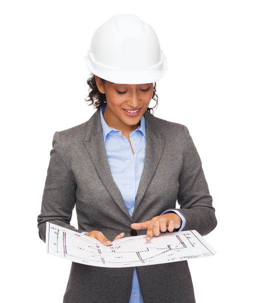 Businesswoman in white helmet with blueprint - Photo, image