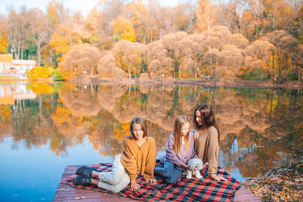 Happy family on a picnic in the park at autumn - Photo, Image