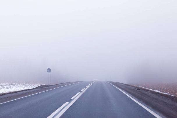 abstract winter road fog snow, landscape view in november transport - Zdjęcie, obraz