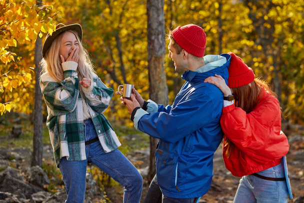 three caucasian friends laughing during hike, adventure in the forest - Фото, зображення