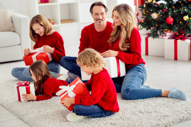 Portrait of five people nice attractive adorable pretty cheerful cheery family members sitting on floor exchanging opening giftboxes in light white apartment indoor - Fotografie, Obrázek