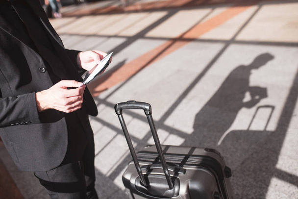 Man getting ready for boarding with his suitcase - 写真・画像