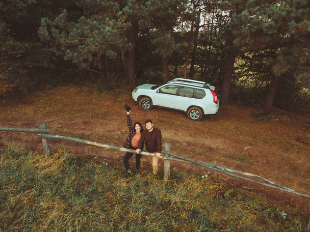aerial view of happy couple country rural scenic suv car on background - Photo, Image