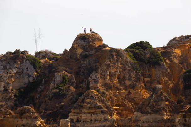 Operating a drone in a cliff, Lagos, Algarve, Portugal. - Fotó, kép