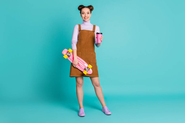 Full length photo of cute nice pretty two lovely buns hairdo youngster lady skater buy mug coffee way college wear fall brown dress violet sweater footwear isolated turquoise color background - Foto, immagini
