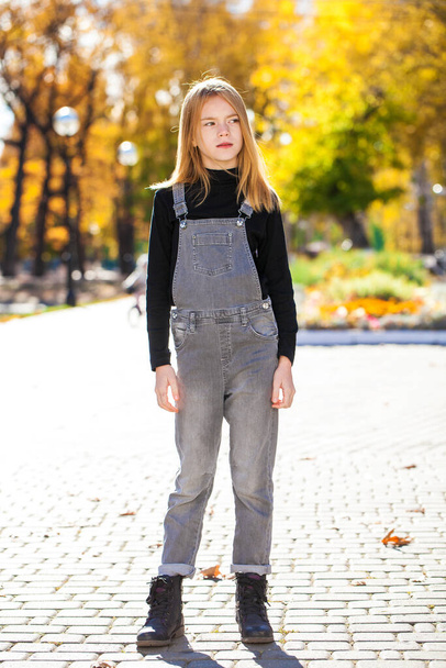 Beautiful teen girl in autumn park - 写真・画像