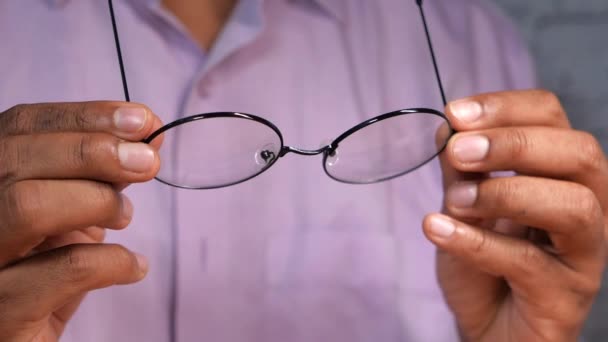 Close up of man hand holding eyeglass in dark. - Footage, Video